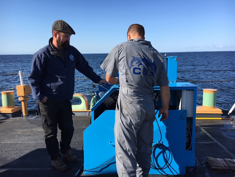 Joe Hoyt and John Bright conduct survey equipment maintenance.