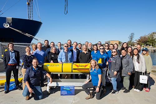 3 Rutgers students professors and the Teledyne Marine team at the Redwing launch ceremony