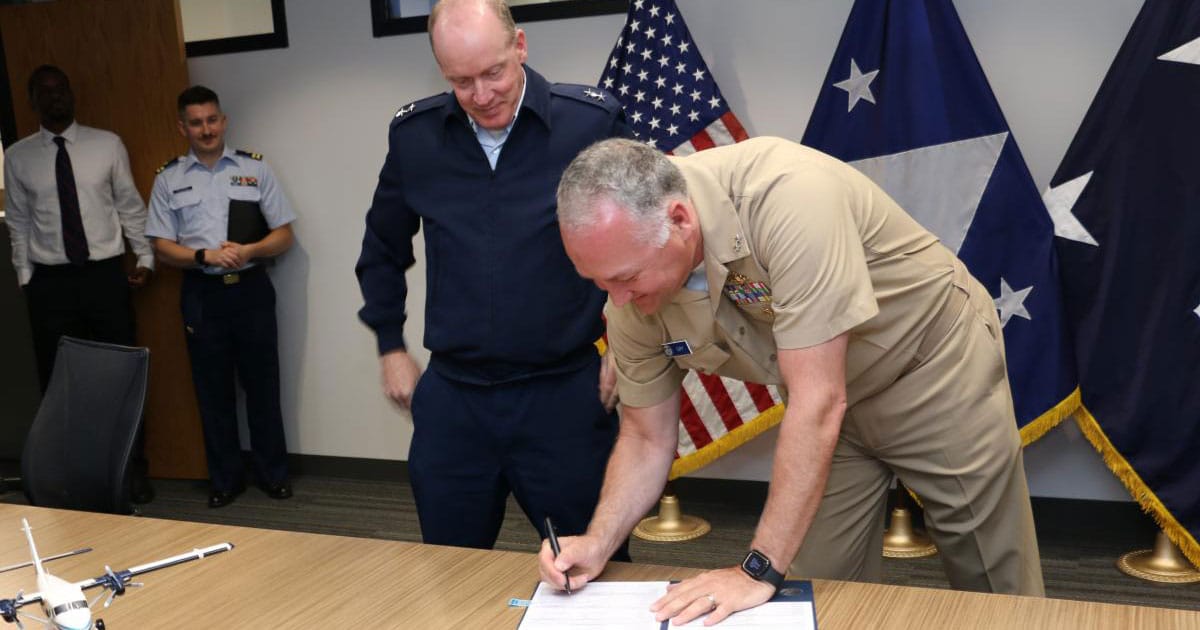 NOAA Corps Rear Adm. Chad Cary (right) and US Coast Guard Rear Adm. Chad Jacoby sign a $2 billion agreement to collaborate on infrastructure initiatives.