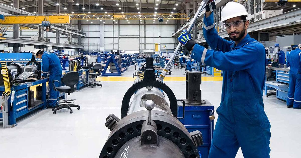 Worker assembling equipment in an industrial manufacturing facility. (Image credit: SLB)